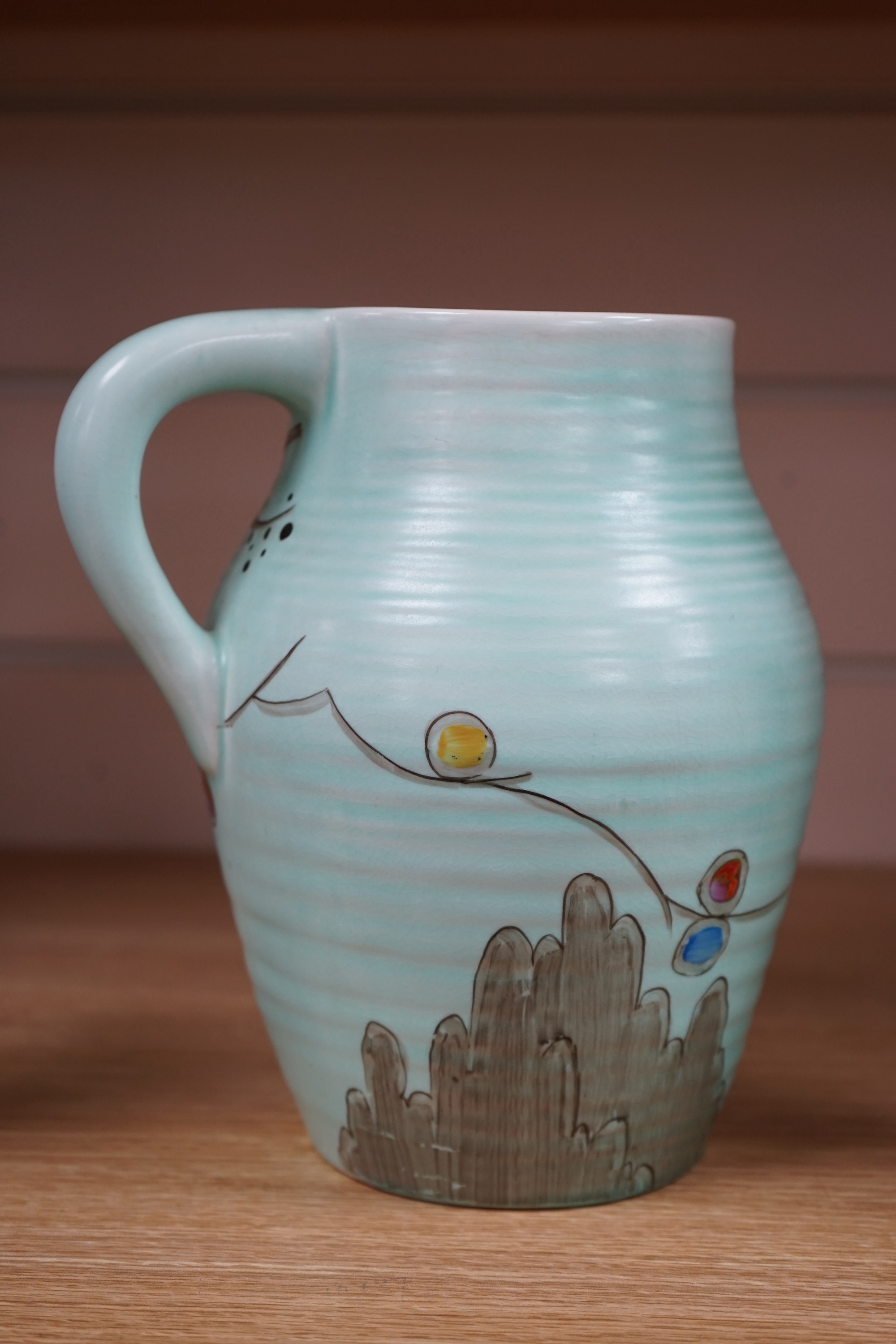 A Clarice Cliff ‘passion fruit’ decorated small lotus jug, 19.5cm. Condition - good